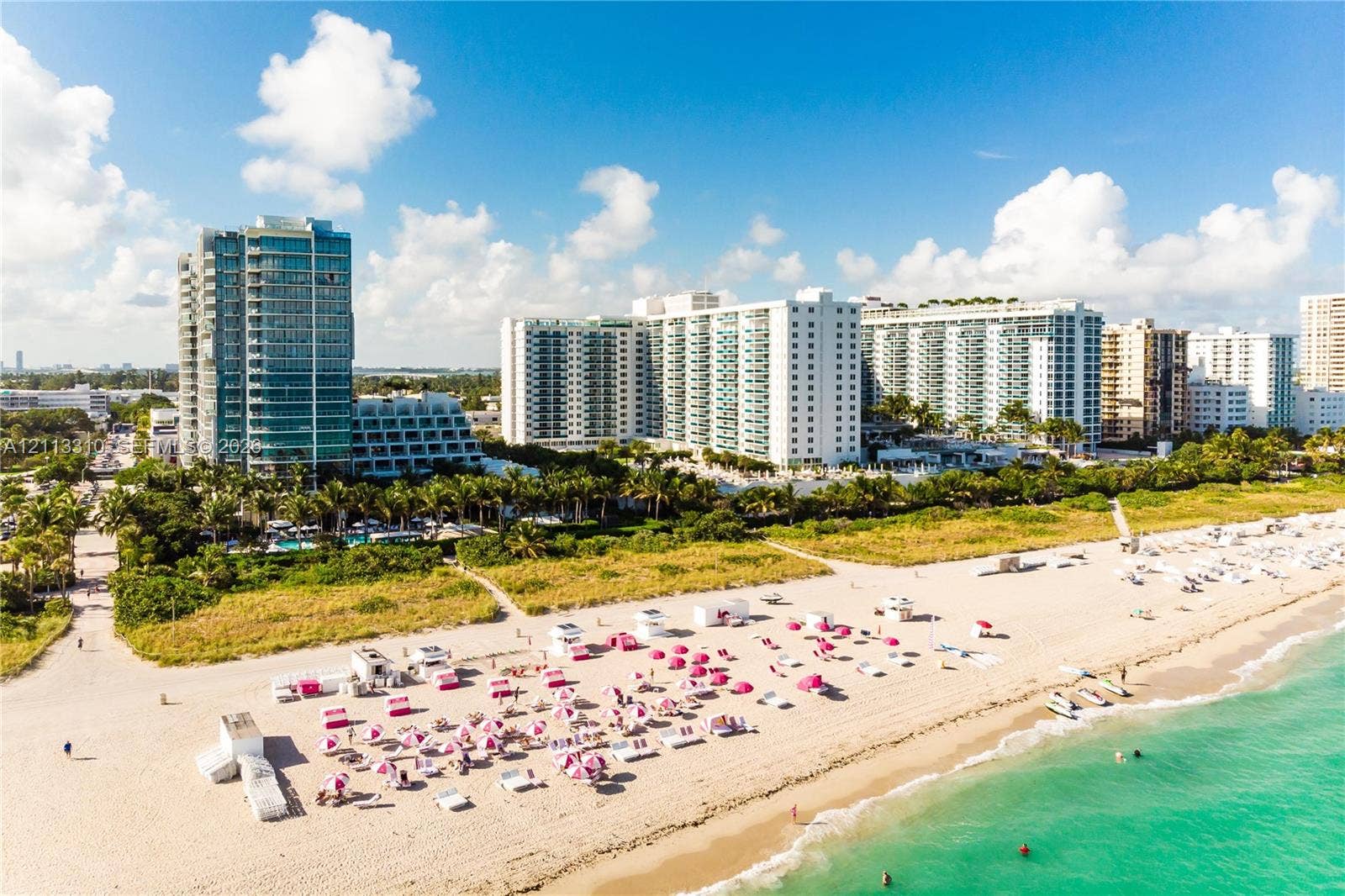 Coastal high-rise buildings featuring glass balconies and direct beach access