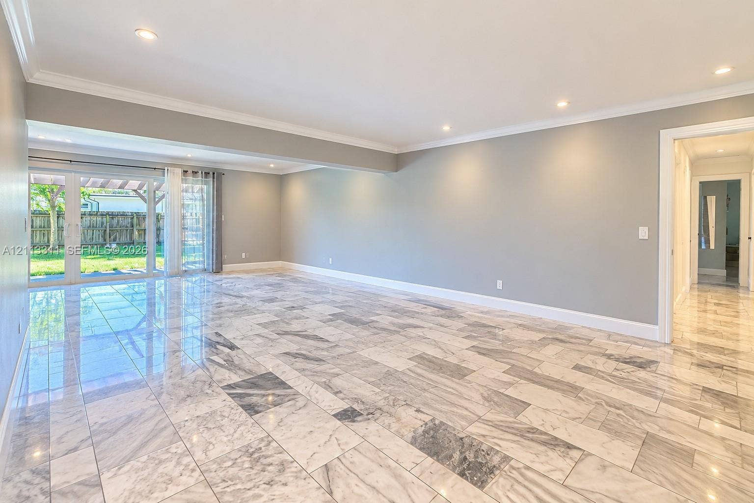 152 SW 59th Avenue, Plantation, Plantation, FL 33317 Polished stone flooring, recessed ceiling lighting, crown molding, and glass sliding doors providing exterior access
