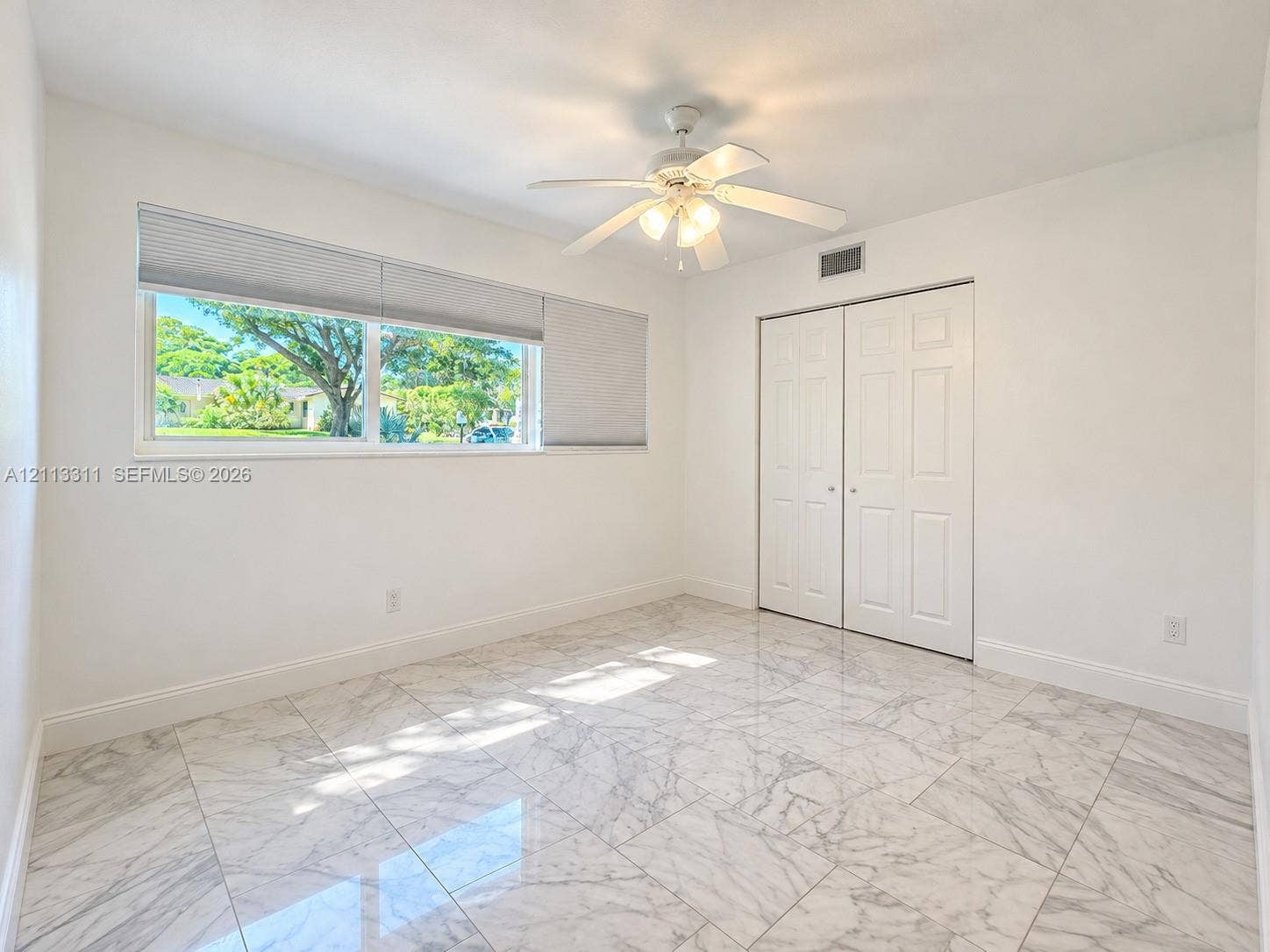 152 SW 59th Avenue, Plantation, Plantation, FL 33317 Polished stone-finish tile flooring, ceiling fan with integrated lighting, dual-panel closet doors, and a wide horizontal window with installed blinds