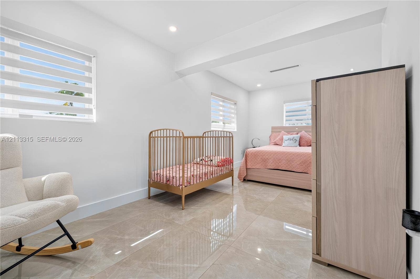 Large-format tile flooring, recessed ceiling lighting, and windows featuring dual-layer shade systems