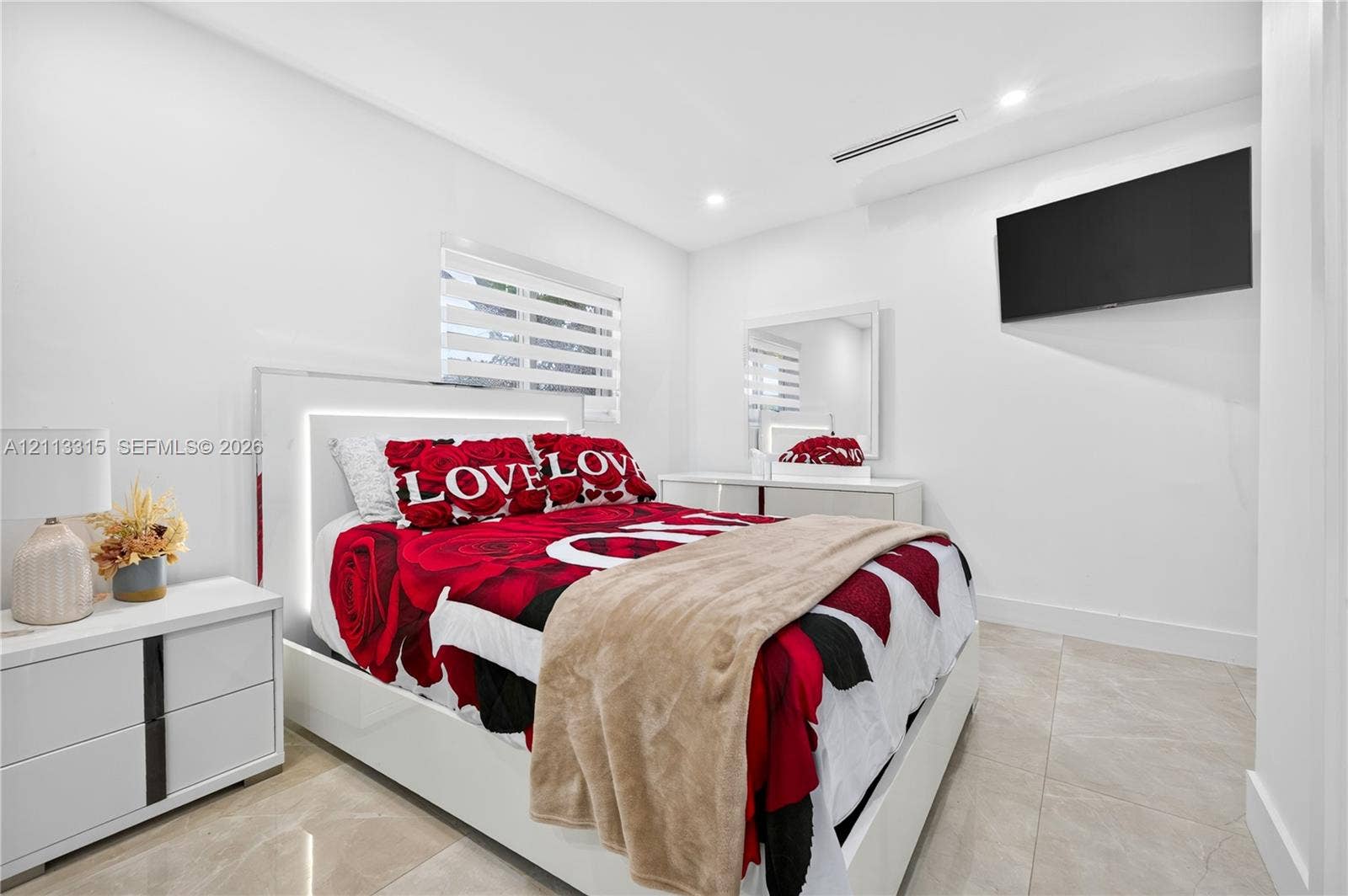 Room featuring neutral stone-finish flooring, recessed ceiling lighting, linear ceiling-mounted climate control, and horizontal window shades