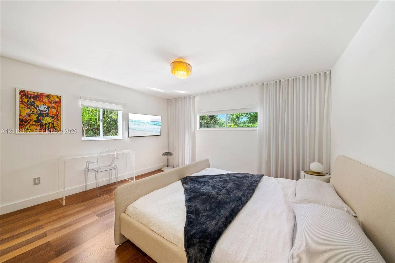 Room featuring wood-finish flooring, recessed lighting, and dual windows