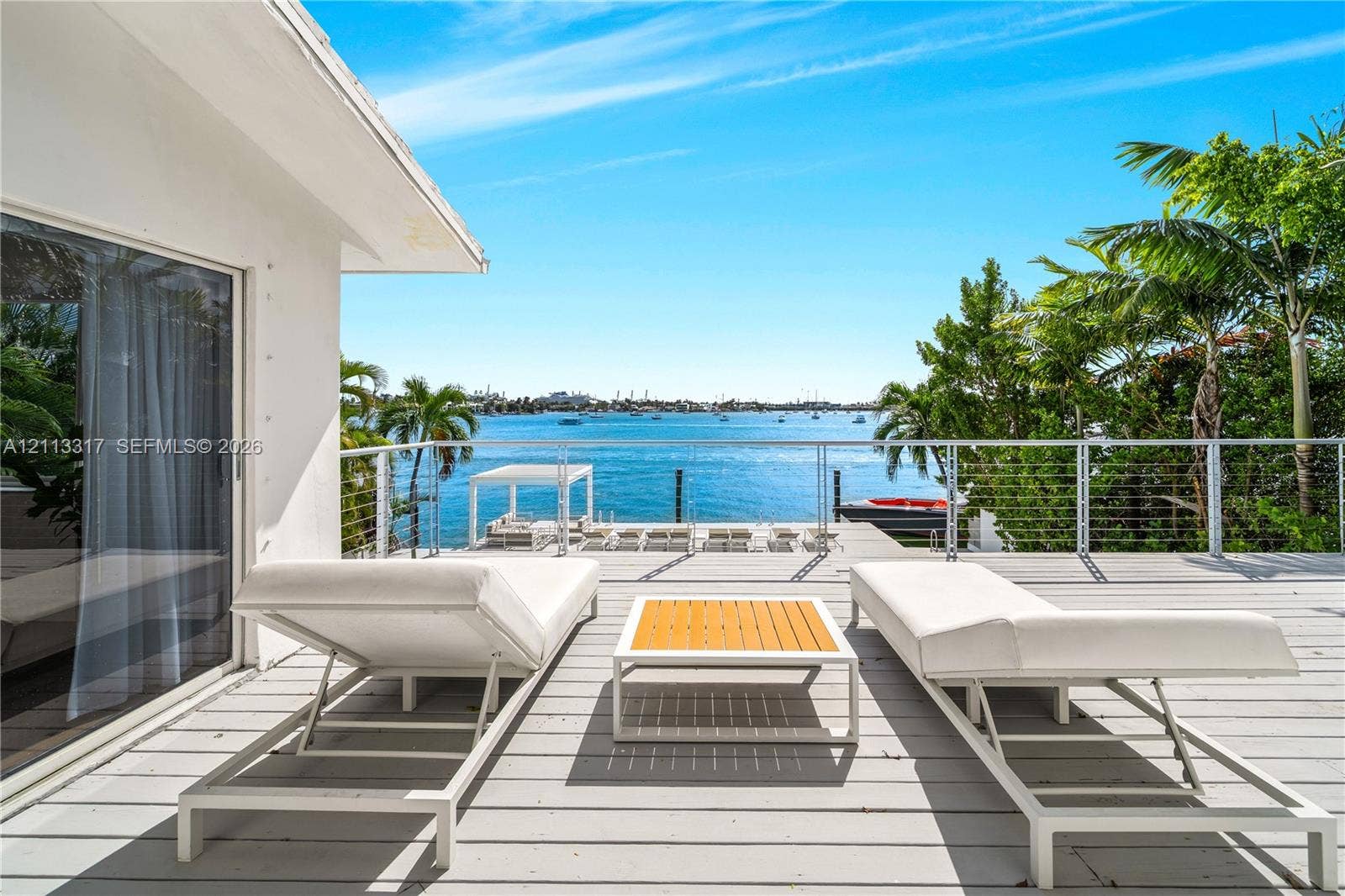 Waterfront deck with wood-finish decking and stainless steel cable railing