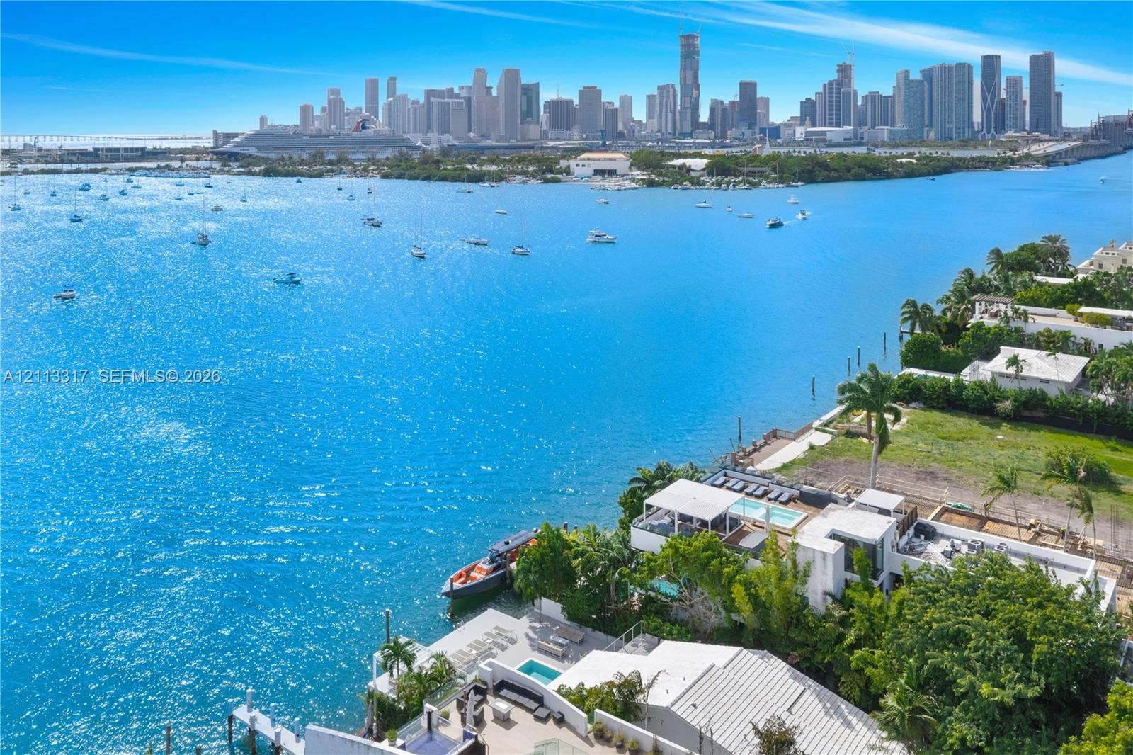 Waterfront property featuring a private boat dock, multi-level terrace, swimming pool, and direct shoreline access