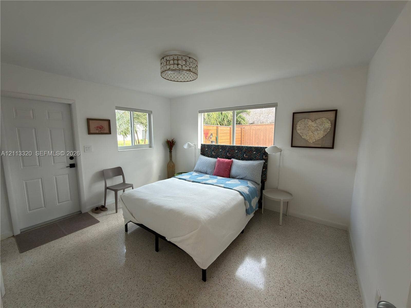 712 NE 25th Avenue, Pompano Beach, FL 33062 Neutral-toned terrazzo flooring, recessed window frames, and decorative drum-style ceiling lighting