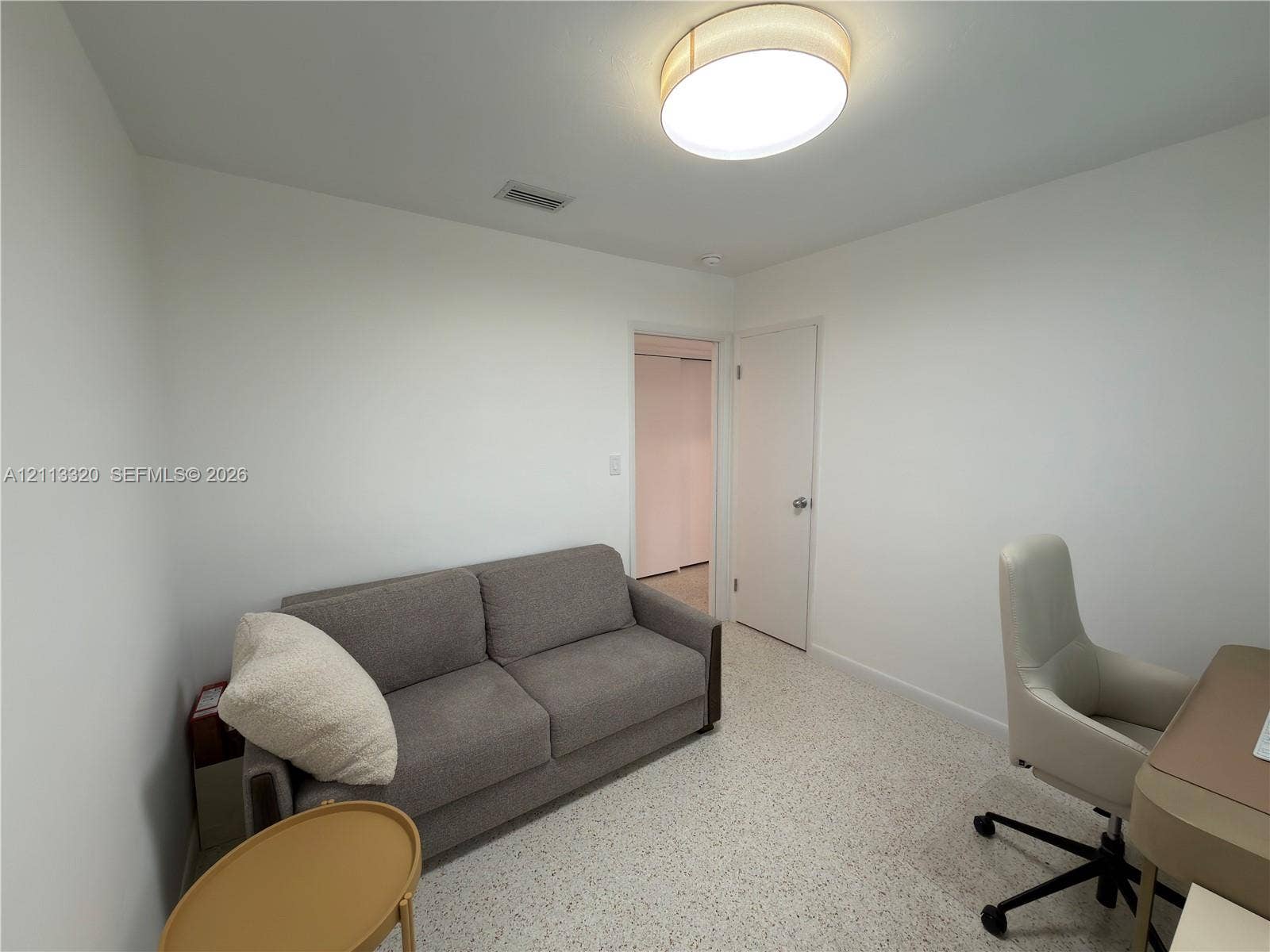 712 NE 25th Avenue, Pompano Beach, FL 33062 Neutral-toned walls, terrazzo flooring, and a circular flush-mount ceiling light fixture