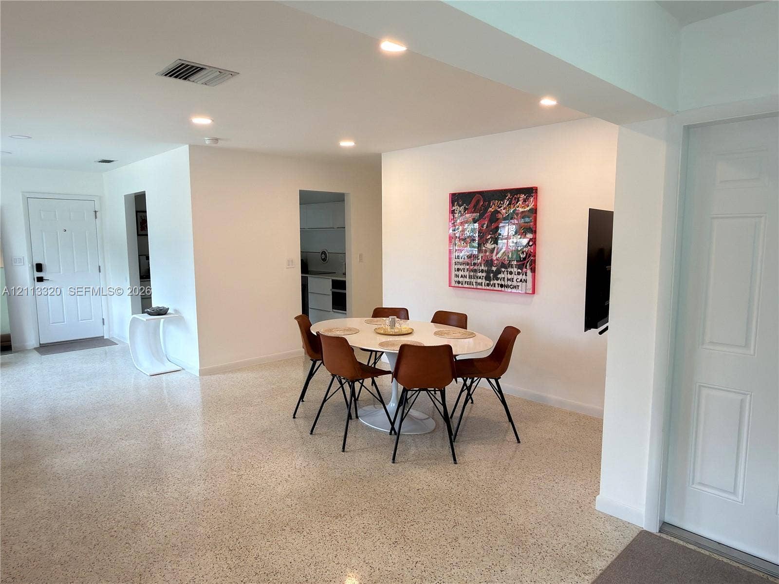 712 NE 25th Avenue, Pompano Beach, FL 33062 Open-concept interior featuring light-toned terrazzo flooring and recessed ceiling lighting