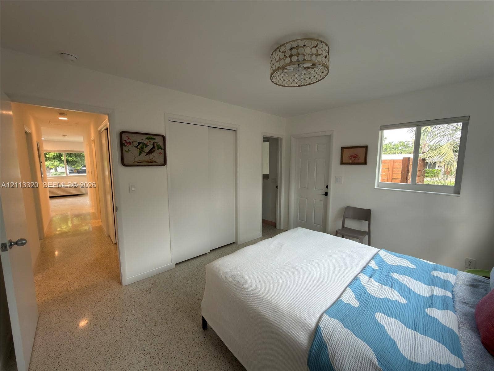 712 NE 25th Avenue, Pompano Beach, FL 33062 Terrazzo flooring, semi-flush mount drum ceiling light with decorative trim, sliding door closet, and multi-pane horizontal sliding window