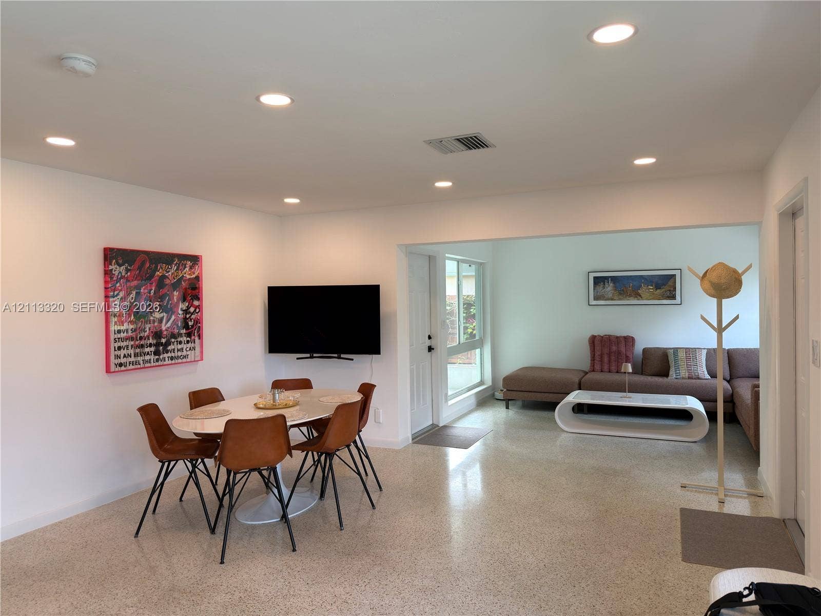 712 NE 25th Avenue, Pompano Beach, FL 33062 Open floor plan featuring polished stone-aggregate flooring and recessed LED lighting throughout