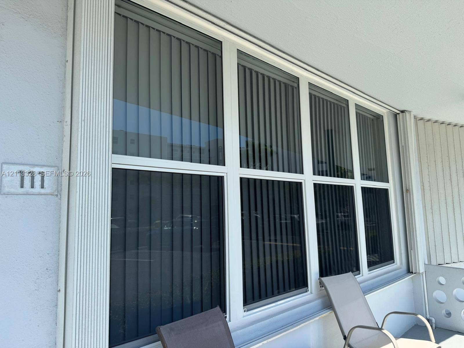 Hallandale Beach, FL 33009 Large, multi-pane window featuring a white frame and integrated vertical blinds