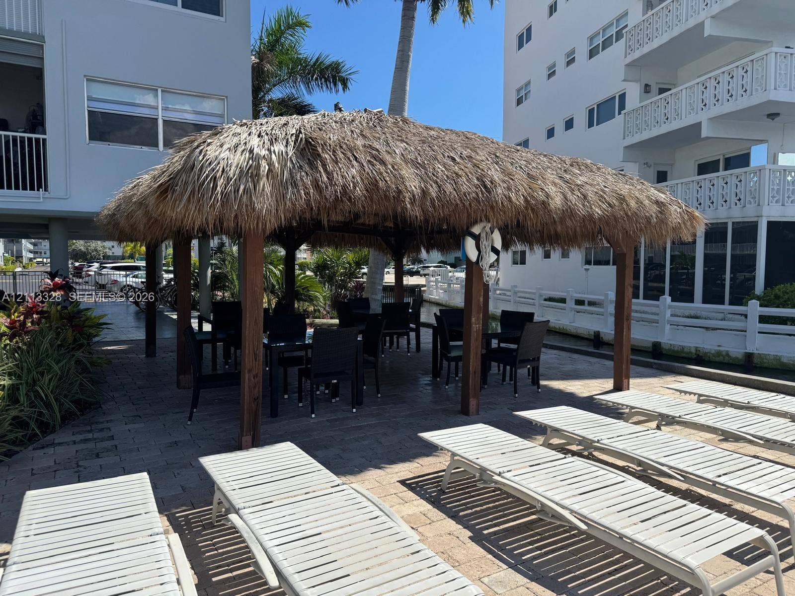 Hallandale Beach, FL 33009 Thatch-roofed gazebo featuring timber support posts set upon a paver patio