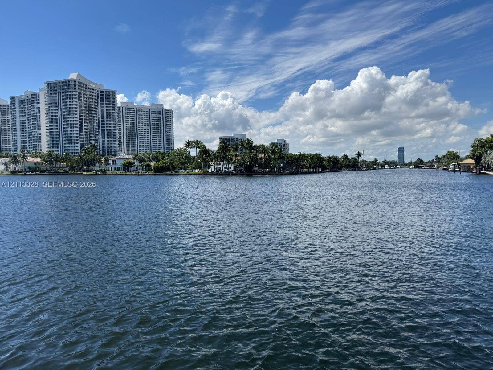 Hallandale Beach, FL 33009 Waterfront property situated on a wide canal with mature palm trees