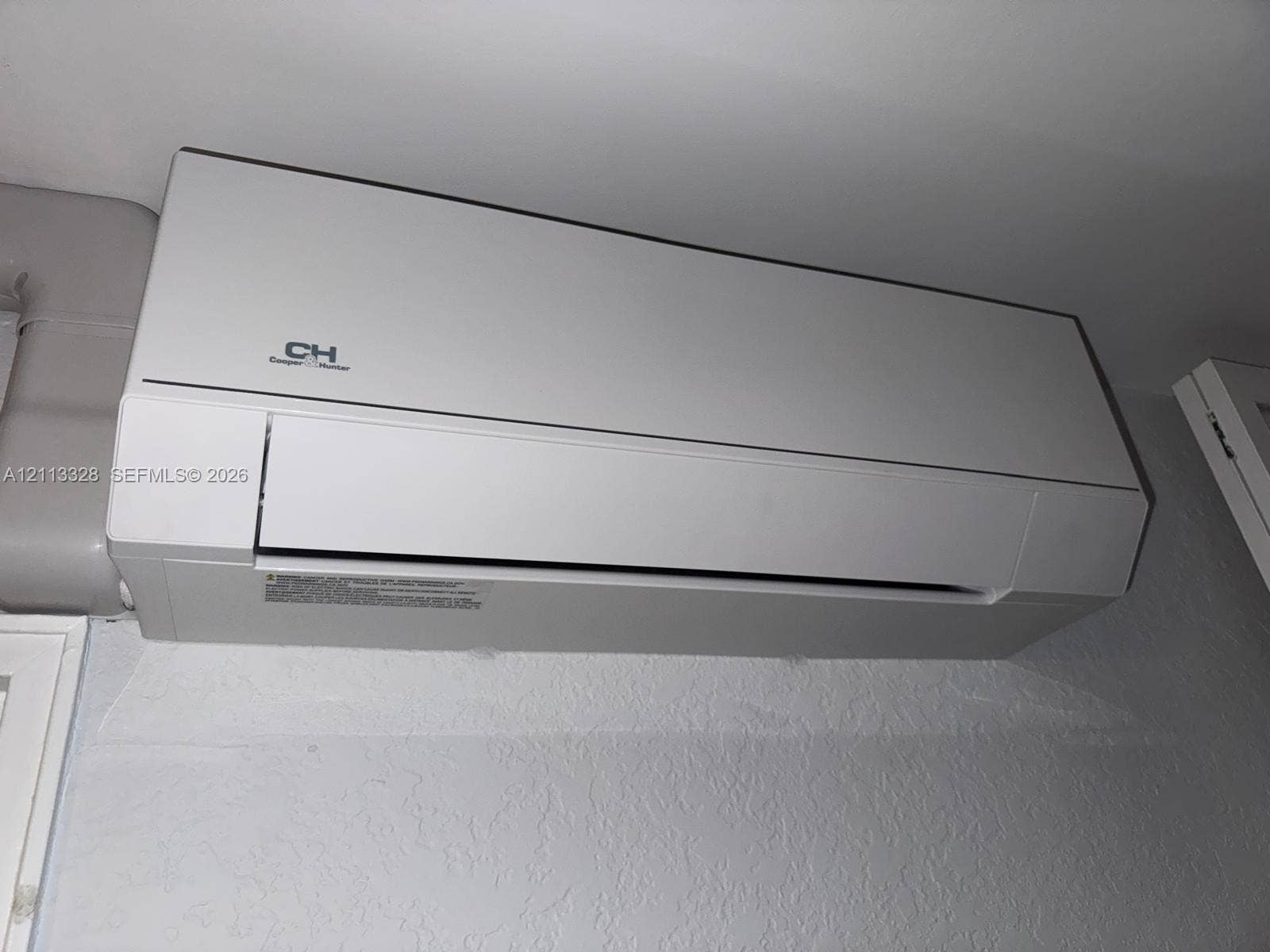 Hallandale Beach, FL 33009 Wall-mounted ductless mini-split climate control unit with a matte white finish
