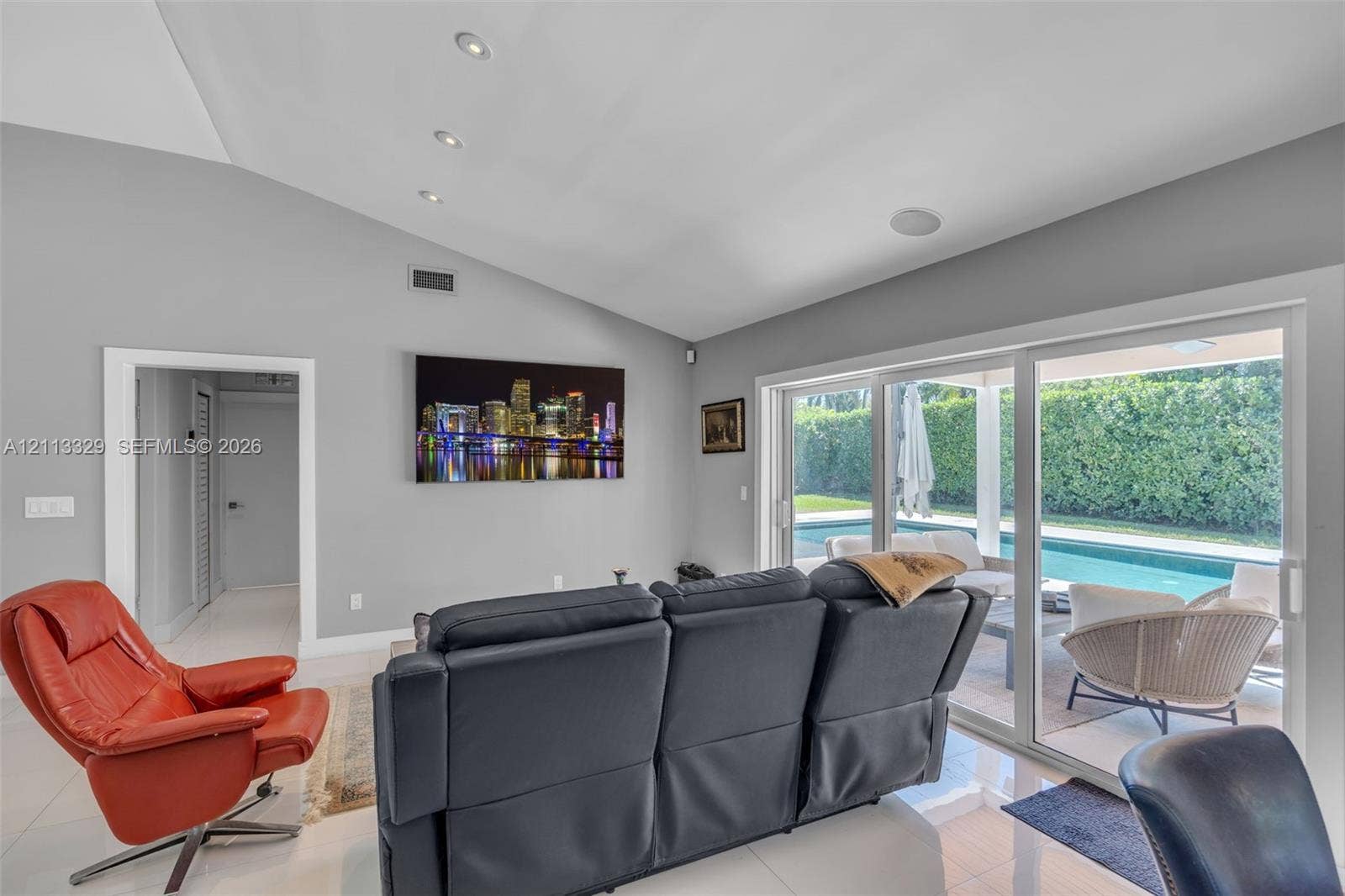 6440 SW 144th Street, Coral Gables, FL 33158 Vaulted ceilings with recessed lighting, tile flooring, and large sliding glass doors providing outdoor access