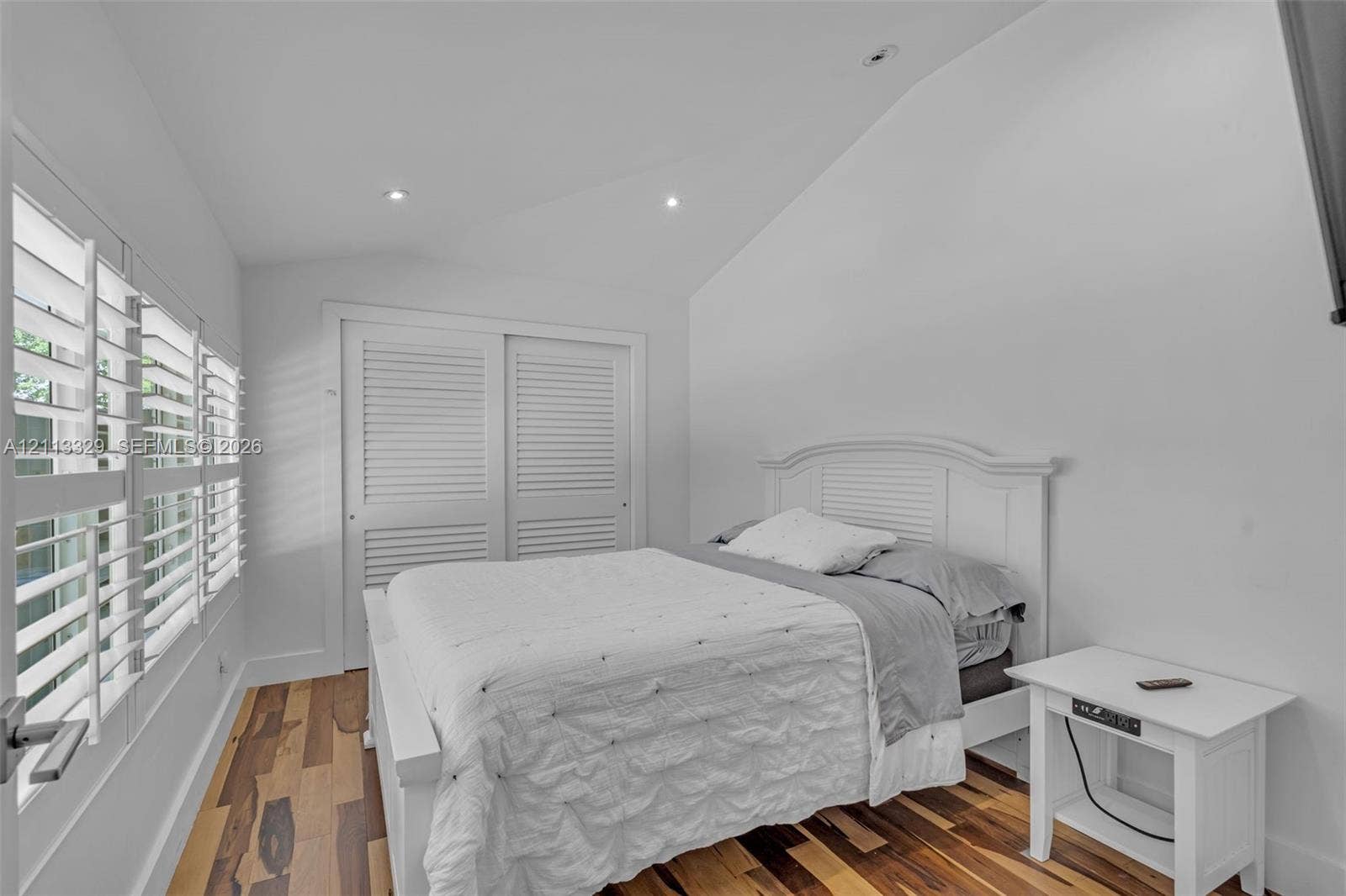 6440 SW 144th Street, Coral Gables, FL 33158 Vaulted ceiling with recessed lighting, wood-finish flooring, and white louvered-style closet doors