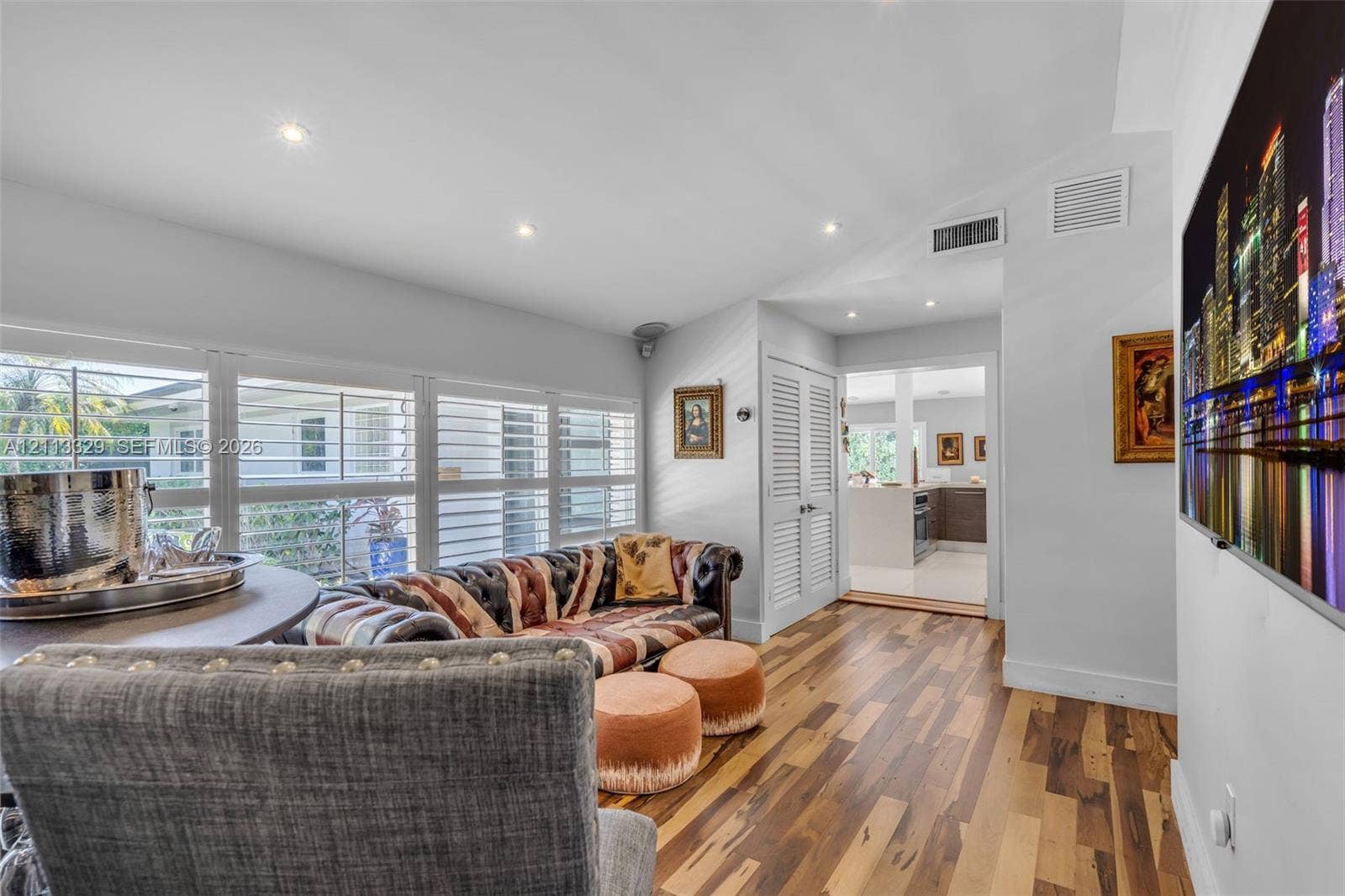 6440 SW 144th Street, Coral Gables, FL 33158 Wood-finish flooring, vaulted ceilings with recessed lighting, and large windows with integrated plantation shutters