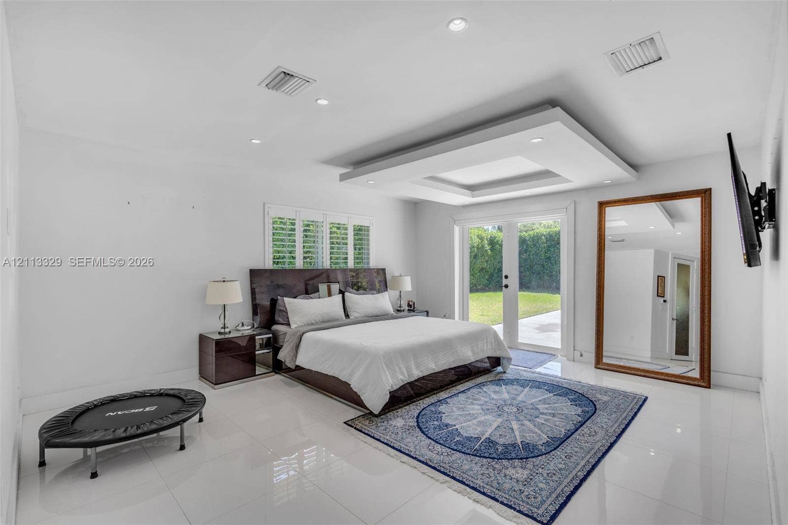 6440 SW 144th Street, Coral Gables, FL 33158 Tray ceiling with recessed lighting, large-format tile flooring, and glass-paned double doors leading to the exterior