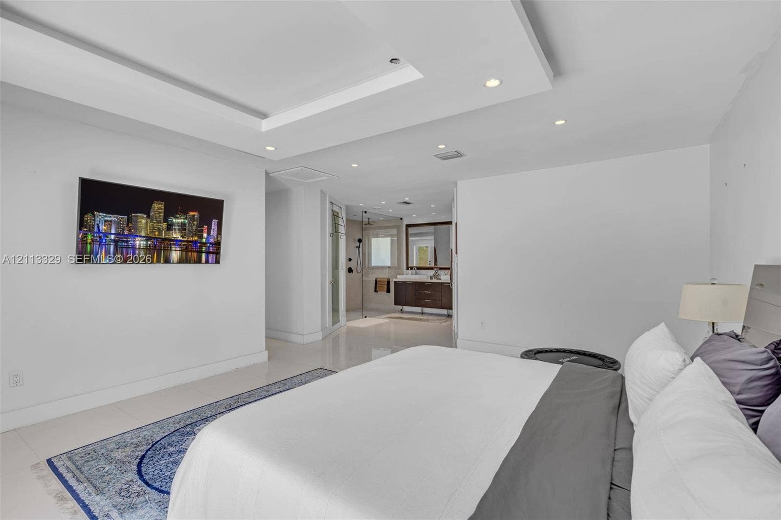 6440 SW 144th Street, Coral Gables, FL 33158 Tray ceiling with recessed lighting, large-format tile flooring, and en-suite bathroom featuring a dark wood vanity