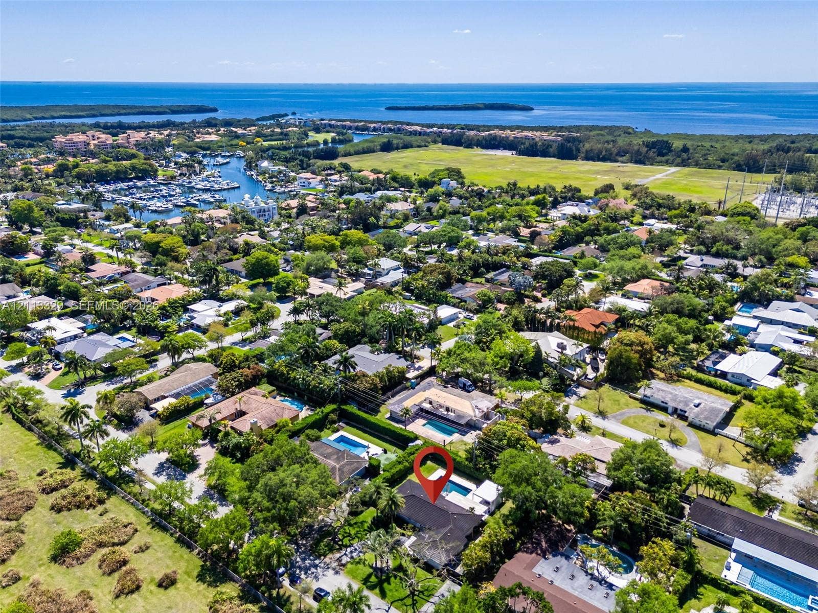 6440 SW 144th Street, Coral Gables, FL 33158 Aerial perspective of a property featuring an in-ground swimming pool, a private screened enclosure, and mature perimeter landscaping