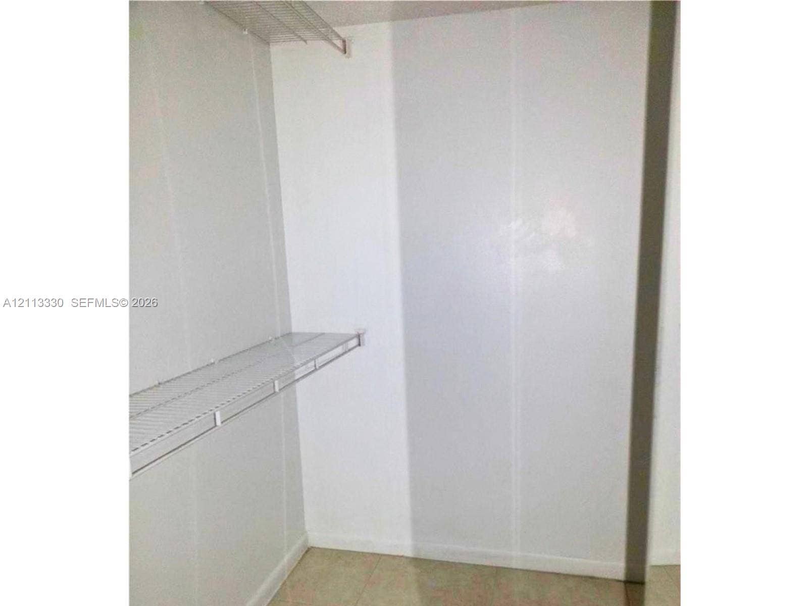 6001 N Falls Cir Drive, #105, Lauderhill, FL 33319 Storage space featuring white walls and two levels of wire shelving