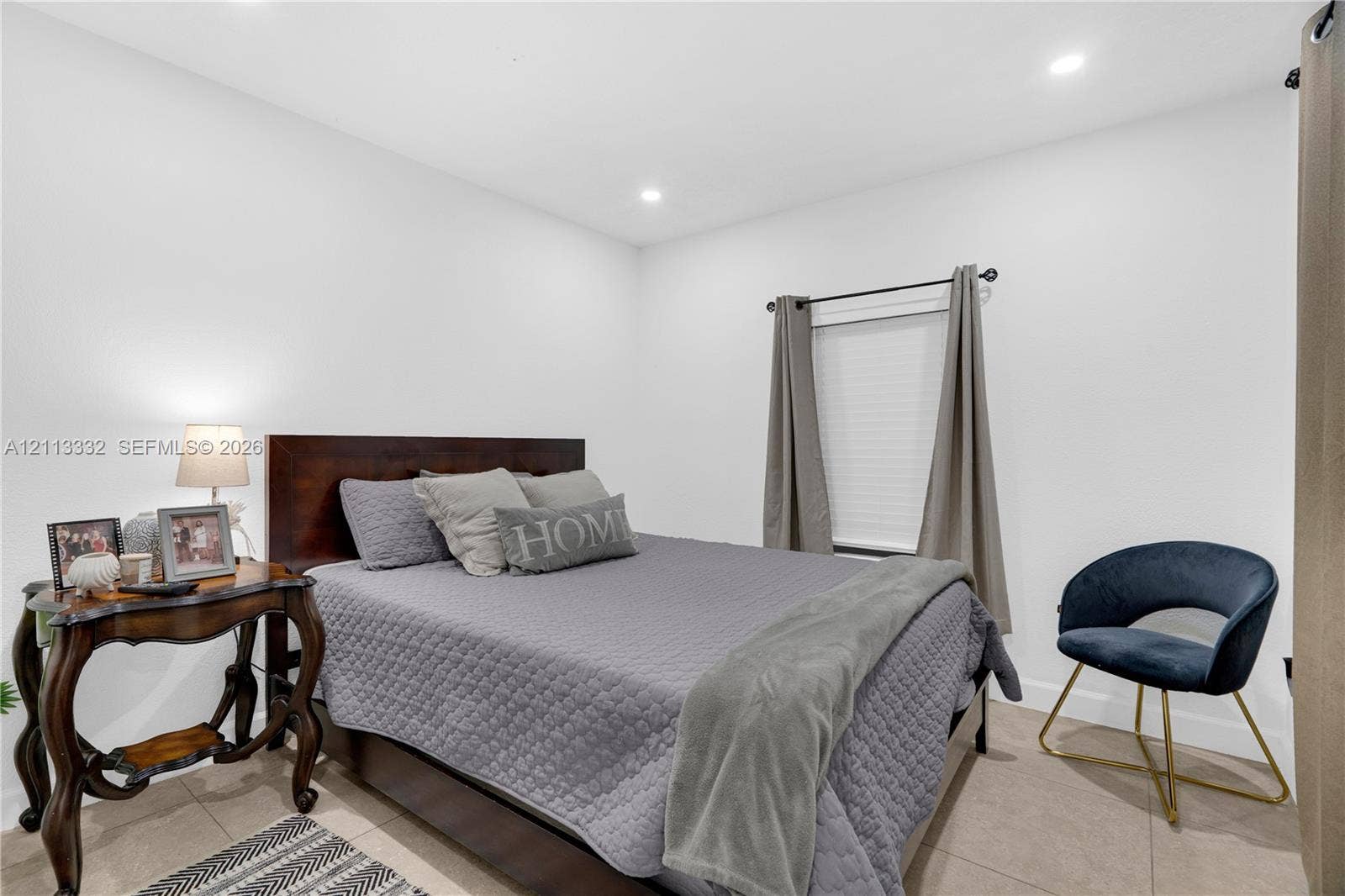 13111 SW 84th Street, Miami, FL 33183 Neutral-toned walls, recessed lighting, tile flooring, and a single window featuring a curtain rod