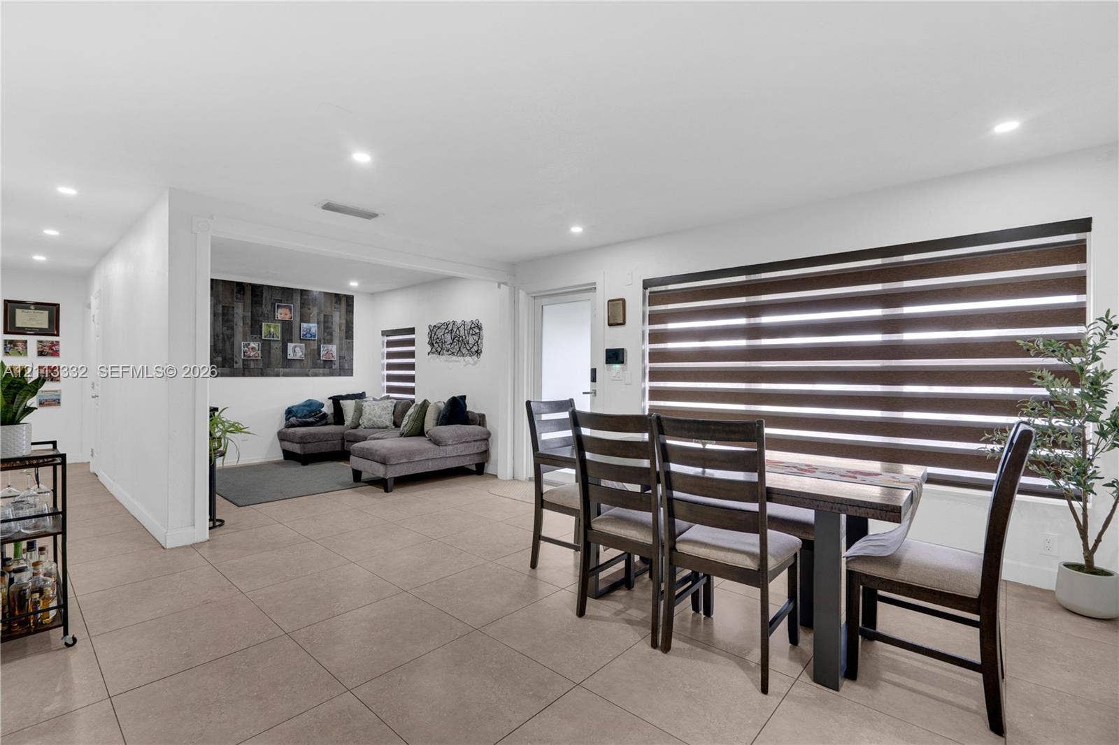 13111 SW 84th Street, Miami, FL 33183 Open-concept interior featuring large-format tile flooring, recessed lighting, and horizontal window shades