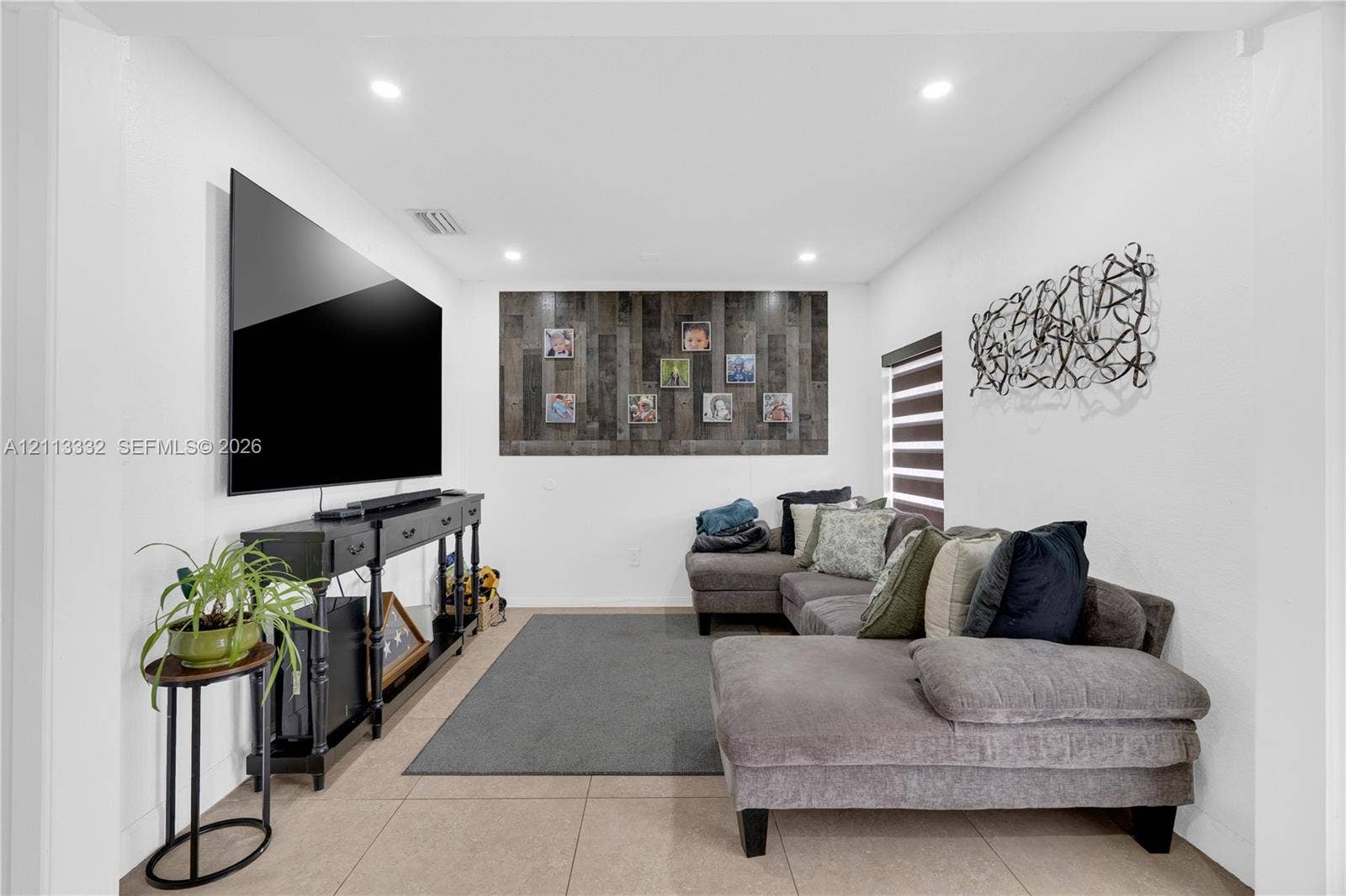 13111 SW 84th Street, Miami, FL 33183 Interior space featuring large-format tile flooring, recessed ceiling lighting, and a textured wood-plank accent wall