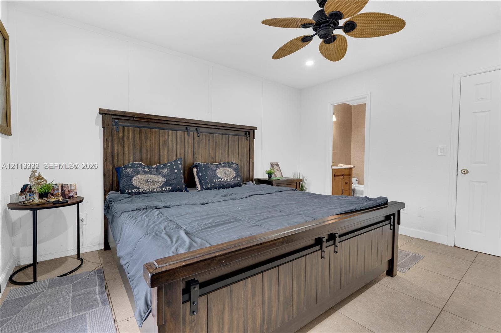 13111 SW 84th Street, Miami, FL 33183 Neutral-toned room featuring large-format tile flooring, a multi-blade ceiling fan, and a six-panel interior door
