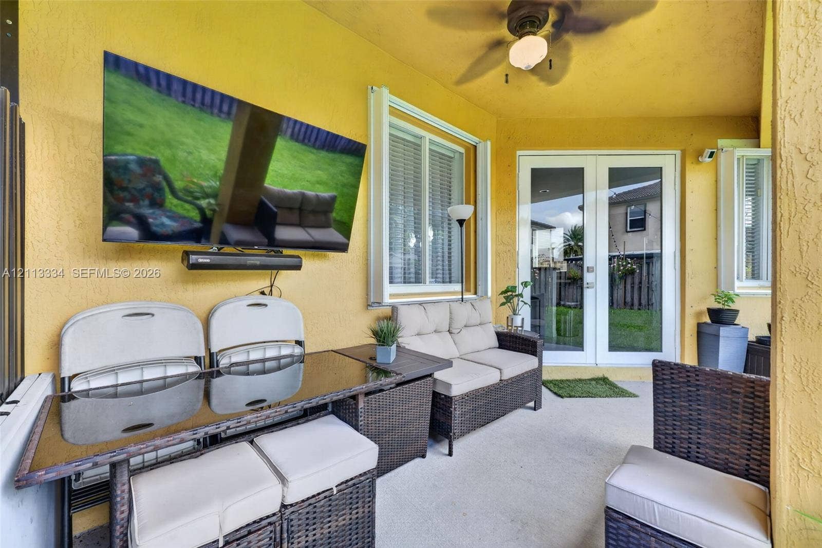 28232 SW 128th Path, Homestead, FL 33033 Covered patio featuring a concrete floor, ceiling fan, and double glass-paned doors