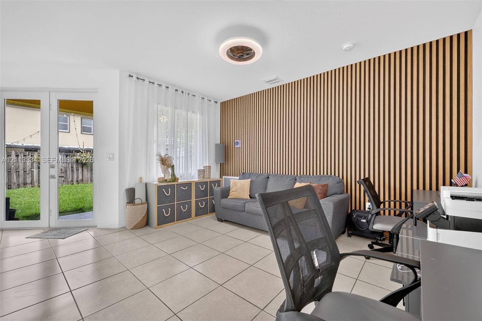 28232 SW 128th Path, Homestead, FL 33033 Vertical wood-slat accent wall, large format tile flooring, and glass-paneled French doors