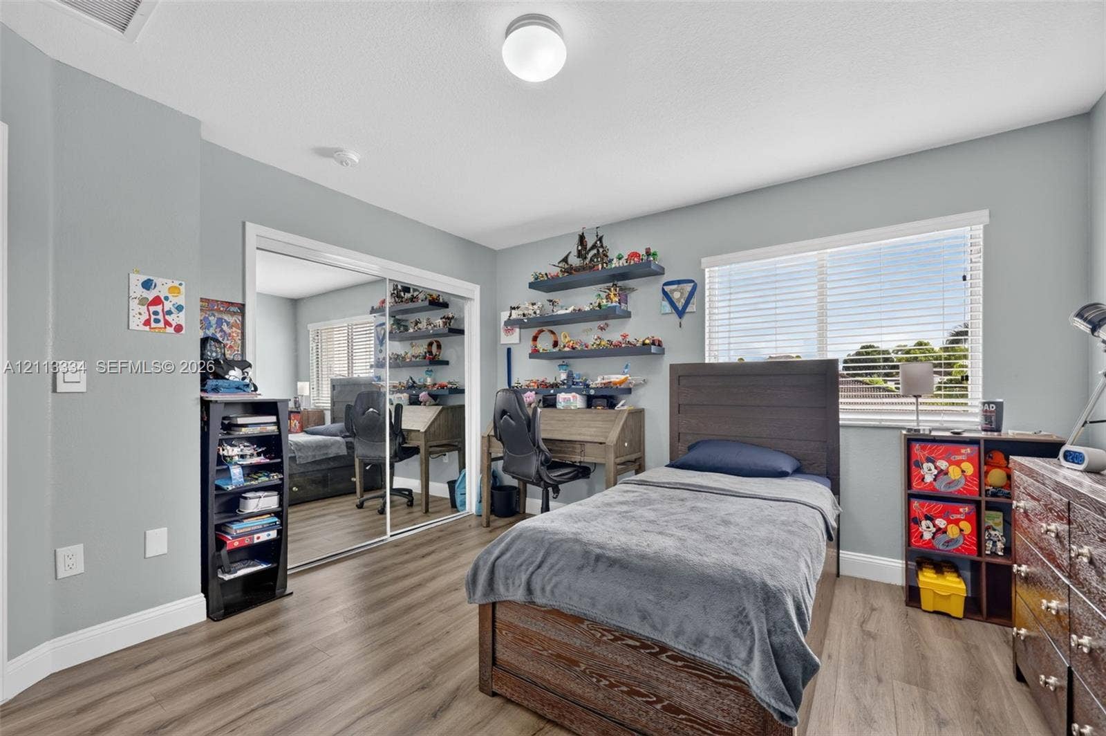 28232 SW 128th Path, Homestead, FL 33033 Wood-finish flooring, sliding mirror-panel closet doors, horizontal window blinds, and overhead flush-mount lighting