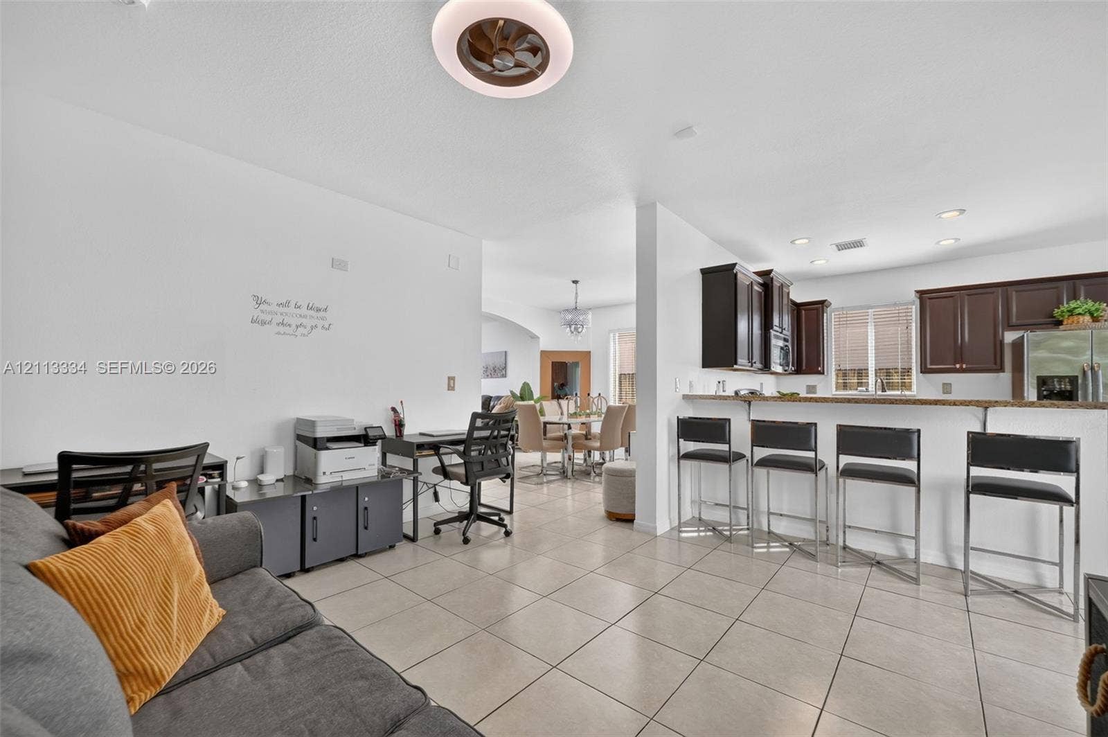 28232 SW 128th Path, Homestead, FL 33033 Open-concept living space featuring large-format tile flooring, a kitchen breakfast bar, recessed lighting, and a contemporary ceiling fan