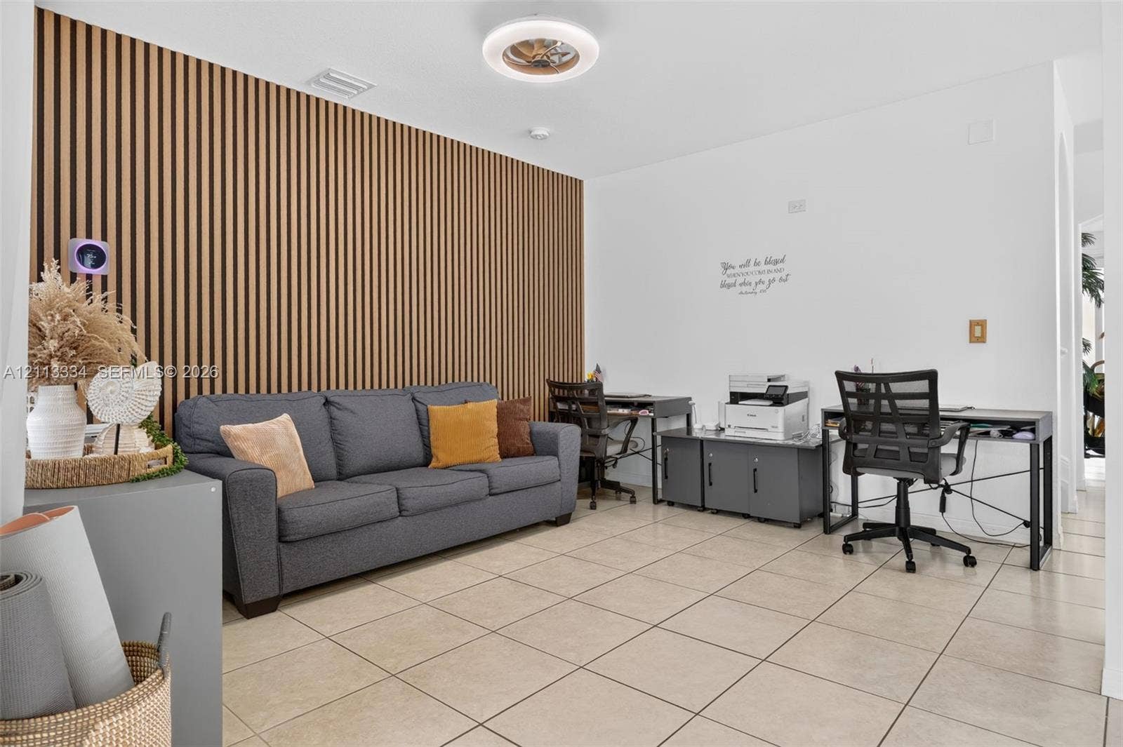 28232 SW 128th Path, Homestead, FL 33033 Vertical wood-slat accent wall, neutral ceramic tile flooring, and circular LED ceiling light fixture