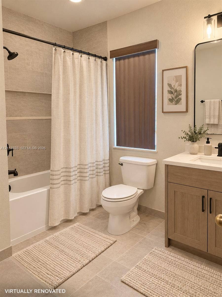 1990 NW 1st Place, Miami, FL 33136 Bathroom featuring a vanity with a light wood-finish cabinet and solid surface countertop, matte black hardware, tile shower surround with integrated shelving, and large-format floor tile