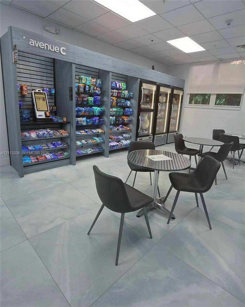 3001 S Ocean Drive, #1539, Hollywood, Hollywood, FL 33019 Built-in shelving unit with integrated electronic payment kiosk, commercial-grade reach-in glass door refrigeration, drop ceiling with recessed lighting, and large-format tile flooring