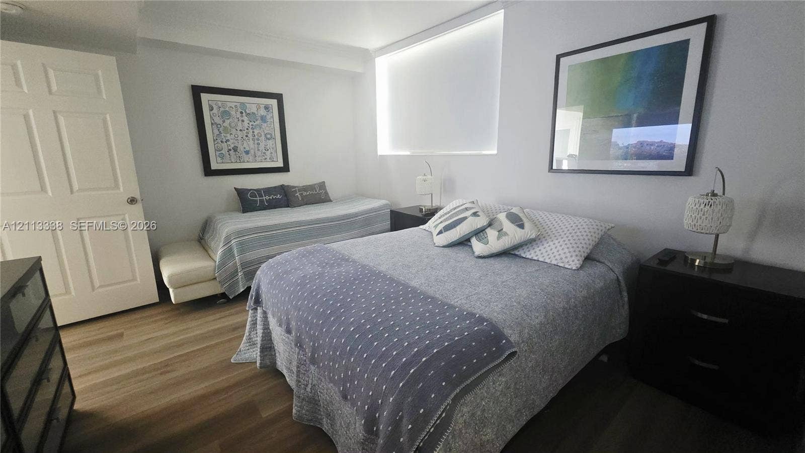 3001 S Ocean Drive, #1539, Hollywood, Hollywood, FL 33019 Room featuring wood-finish flooring, a six-panel door, and a horizontal rectangular window