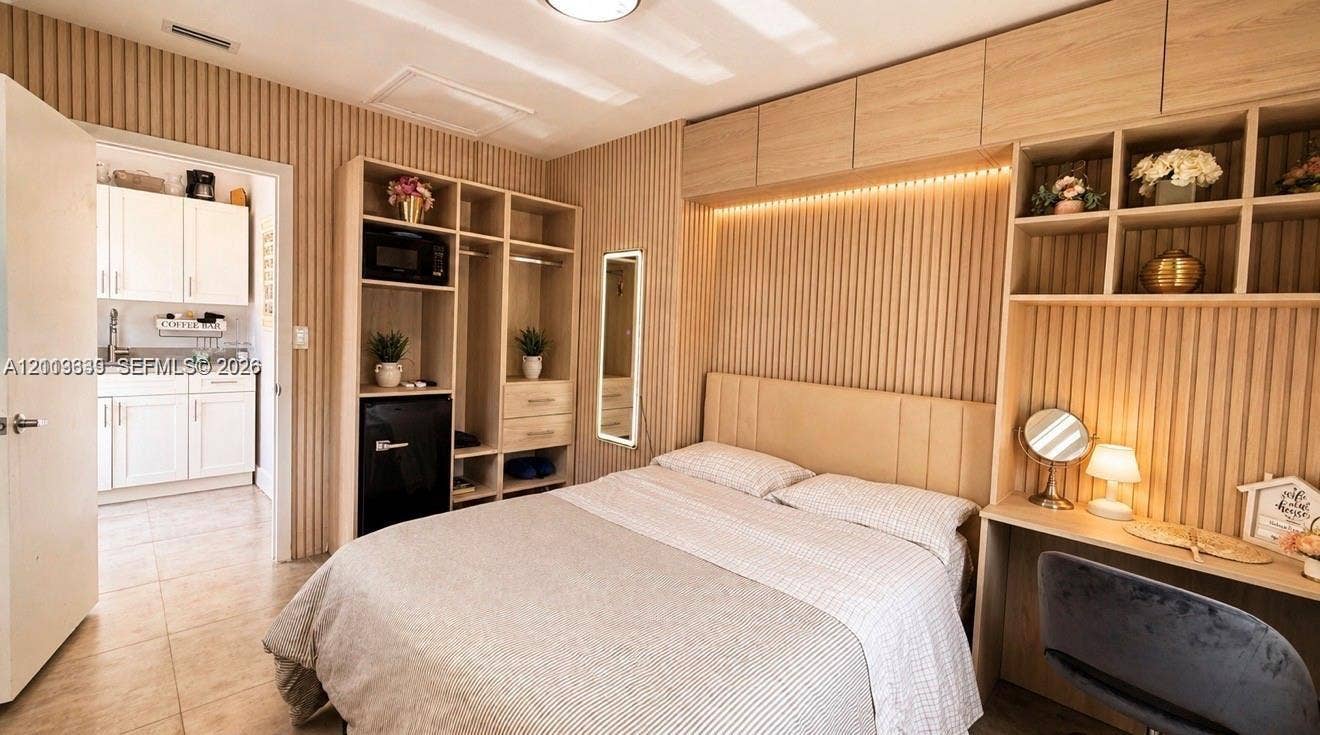 2425 SW 21st Terrace, #1, Miami, Miami, FL 33145 Built-in floor-to-ceiling slatted wood-finish cabinetry, integrated desk, neutral tile flooring, and custom overhead recessed lighting