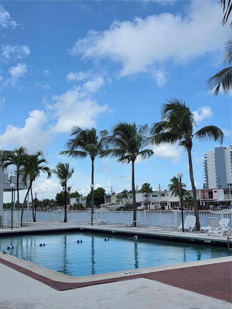 7207 Bay Drive, #2, Miami Beach, Miami Beach, FL 33141 Swimming pool featuring a concrete deck against a waterfront backdrop