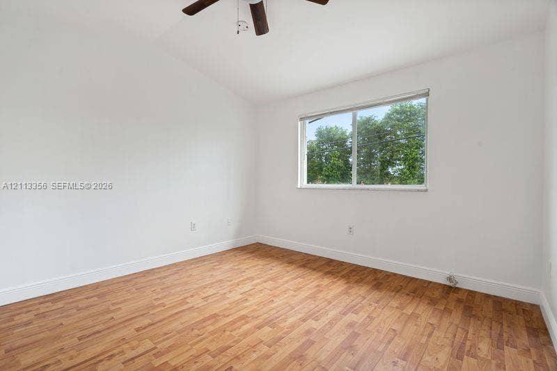 8715 SW 152nd Avenue, #312, Miami, Miami, FL 33193 Interior room featuring vaulted ceilings, wood-finish flooring, and a ceiling fan