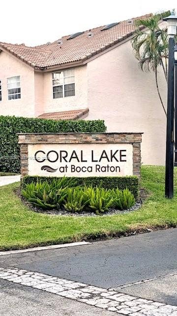 9395 Boca River Circle, Boca Raton, Boca Raton, FL 33434 Community entrance signage featuring stone-veneer pillars and integrated landscaping with manicured shrubbery