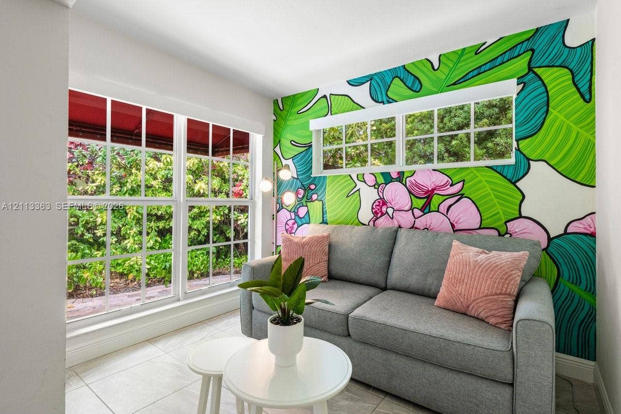 617 NE 9th Avenue, #72, Fort Lauderdale, Fort Lauderdale, FL 33304 Large grid-pane windows with natural light, tiled flooring, and a decorative mural wall feature