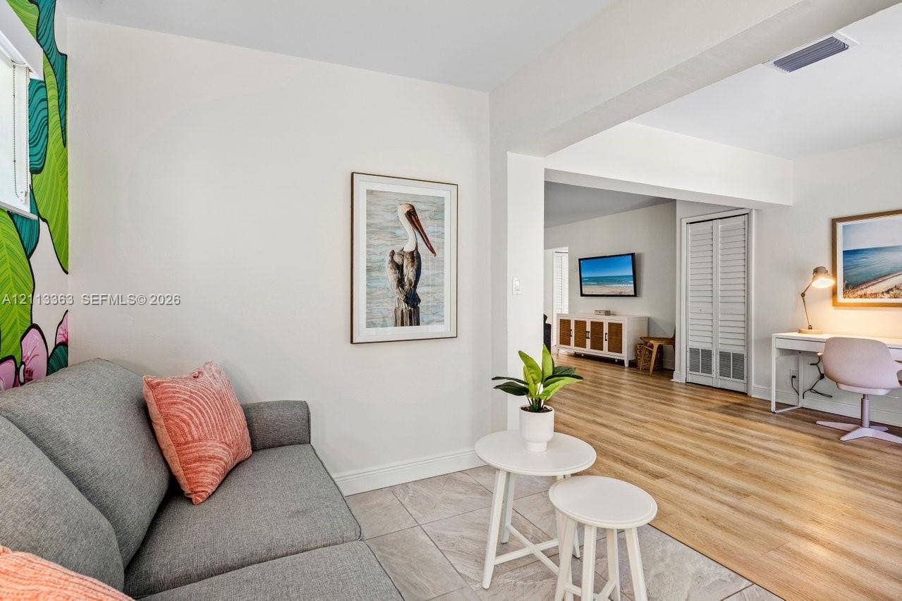 617 NE 9th Avenue, #72, Fort Lauderdale, Fort Lauderdale, FL 33304 Neutral-toned interior featuring wood-finish flooring, large-format tile flooring, and white louvered closet doors