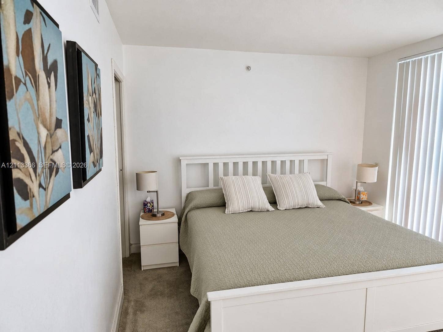 9499 Collins Avenue, #904, Surfside, FL 33154 Neutral-toned carpeting and vertical window blinds
