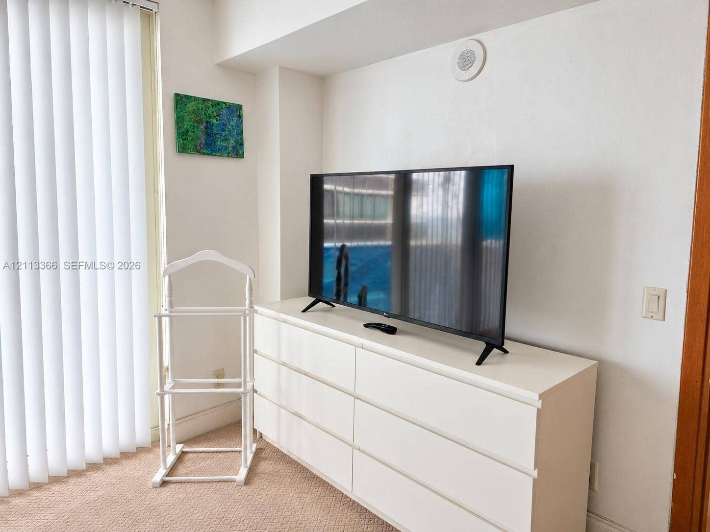 9499 Collins Avenue, #904, Surfside, FL 33154 Neutral-toned carpeting, floor-to-ceiling vertical blinds, and recessed ceiling speaker