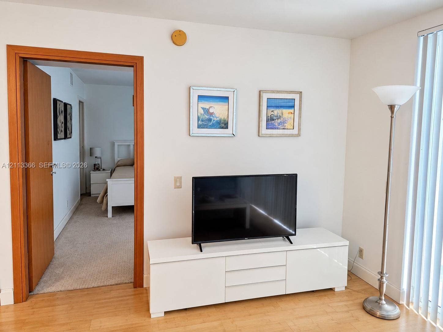 9499 Collins Avenue, #904, Surfside, FL 33154 Wood-finish flooring, smooth interior walls, and vertical window blinds