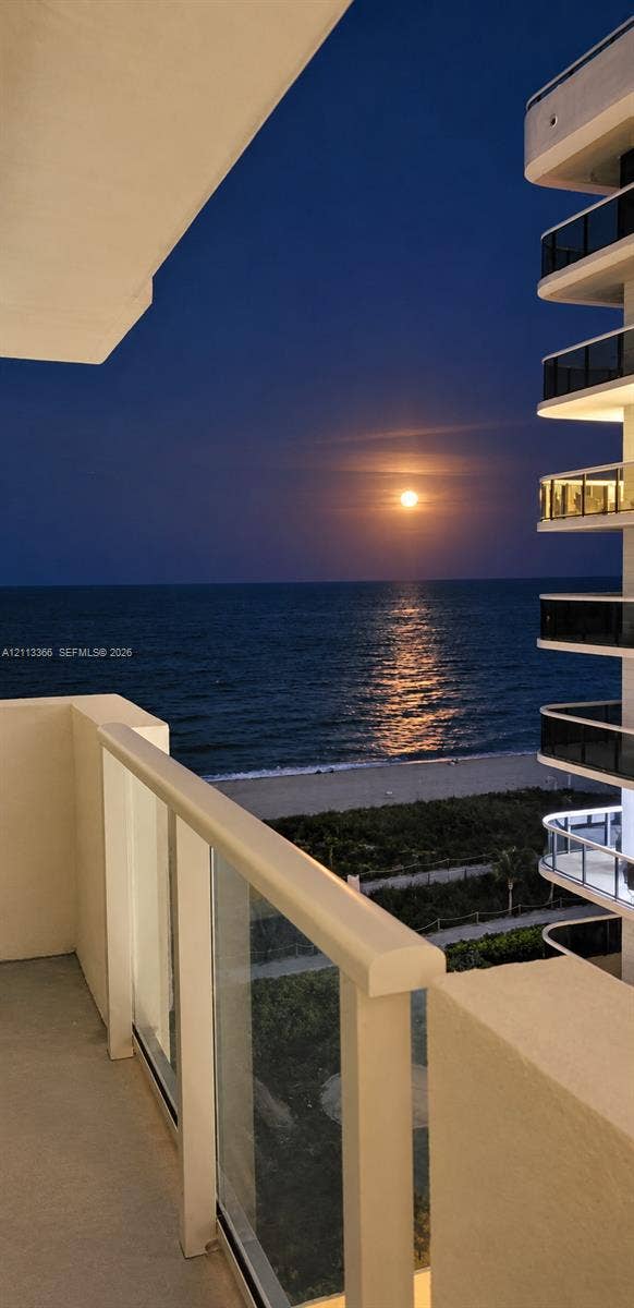 9499 Collins Avenue, #904, Surfside, FL 33154 Covered balcony with glass panel railing overlooking the ocean and coastline