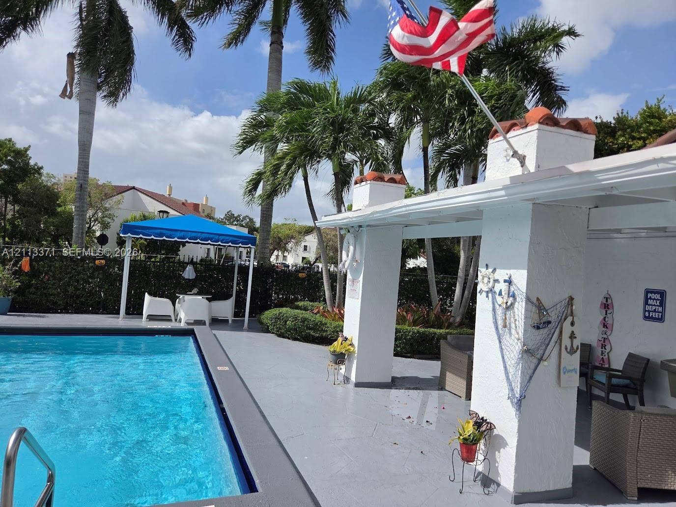 9439 Fontainebleau Boulevard, #104, Miami, Miami, FL 33172 Swimming pool with concrete decking, covered patio area, and mature palm trees
