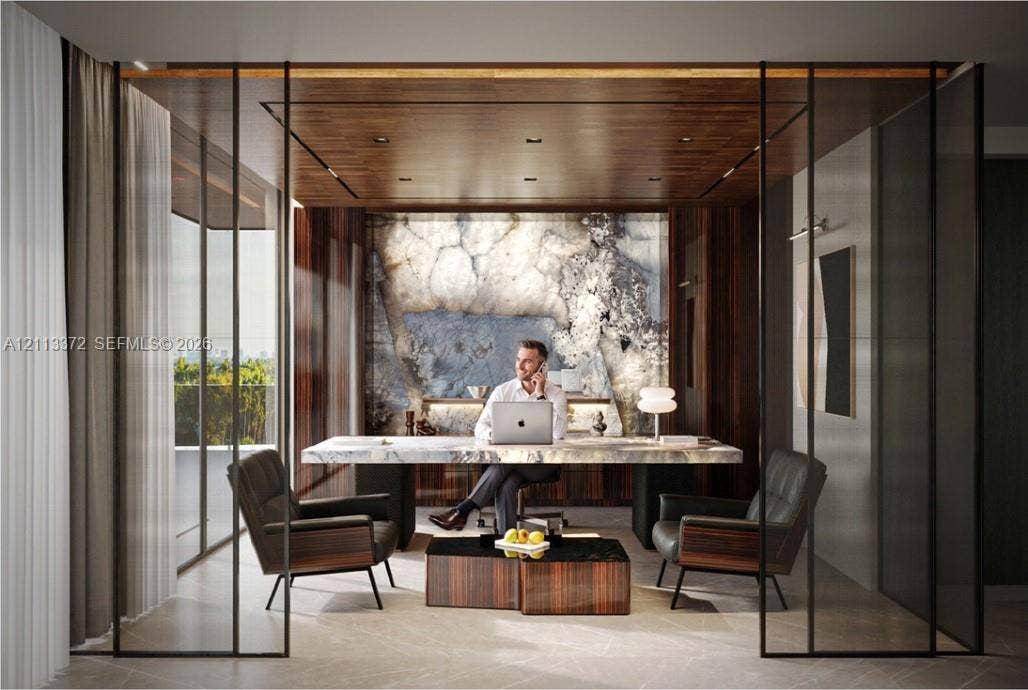 3312 NE 16th Court, Fort Lauderdale, FL 33305 Enclosed office space featuring floor-to-ceiling black metal-framed glass partitions, a backlit stone accent wall, rich wood-paneled ceiling, integrated recessed lighting, and large-format tile flooring