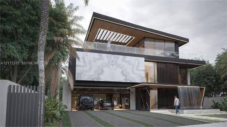 3312 NE 16th Court, Fort Lauderdale, FL 33305 Contemporary multi-level exterior featuring a stone-clad facade, a covered ground-level parking area, a glass-railed upper terrace with a wood-paneled ceiling, and a built-in water feature