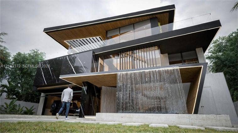 3312 NE 16th Court, Fort Lauderdale, FL 33305 Contemporary architectural exterior featuring a tiered design, integrated water feature, wood-finish soffits, stone cladding with veining, and glass balcony railings